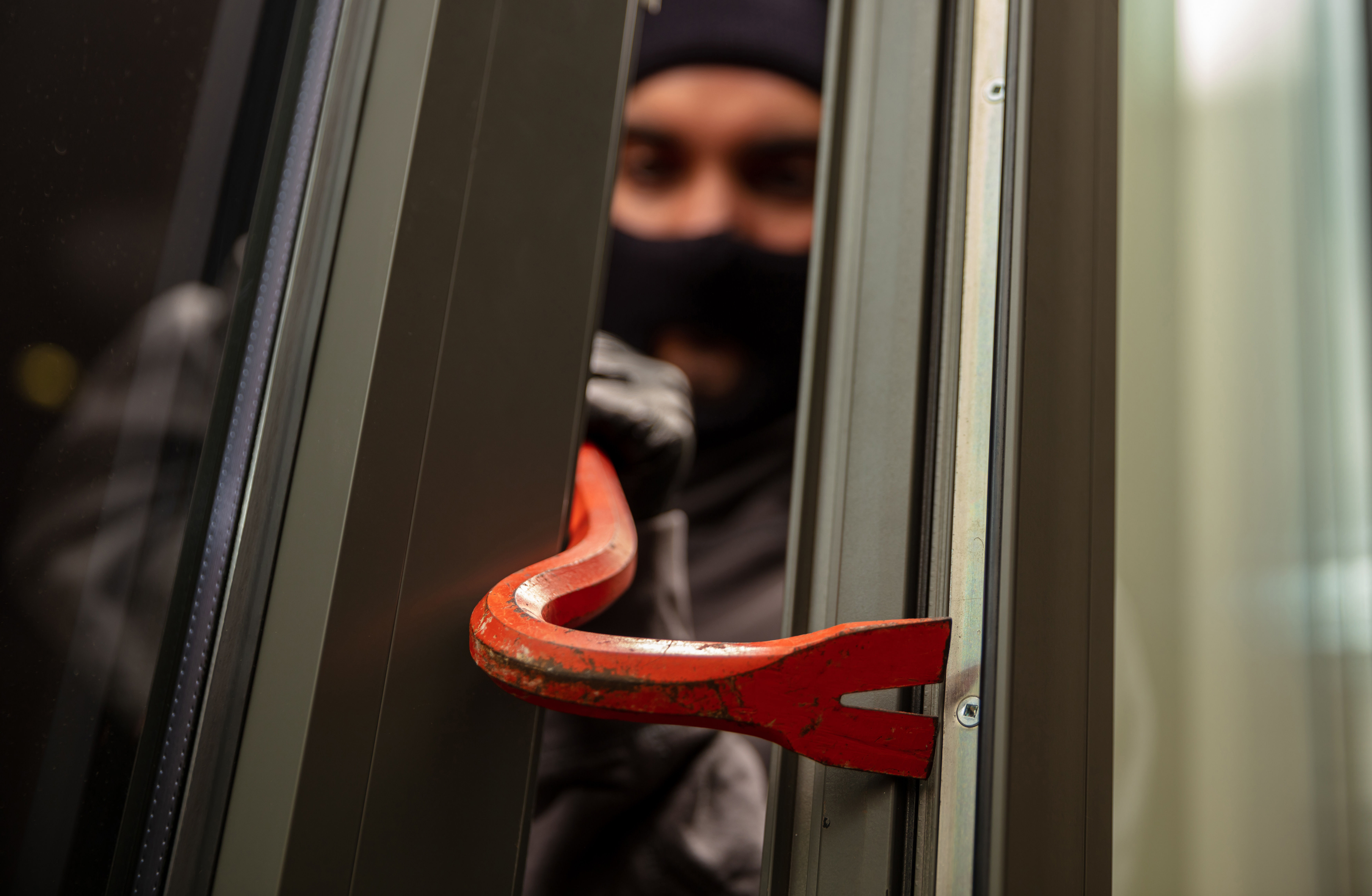 burglar using crowbar to force open window 2026 03 16 02 10 10 utc
