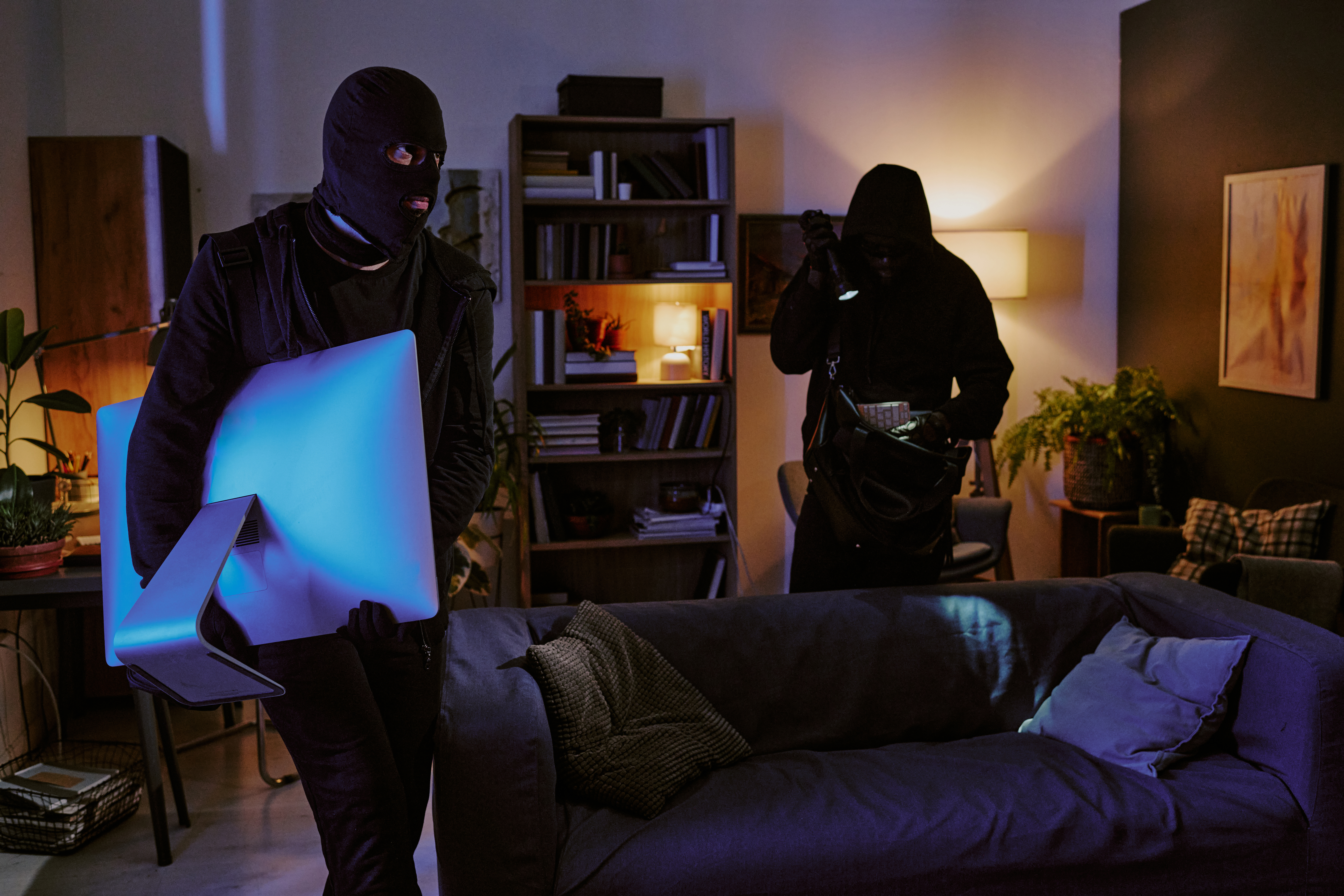 masked figures stealing a computer monitor from ho 2026 03 18 14 51 05 utc